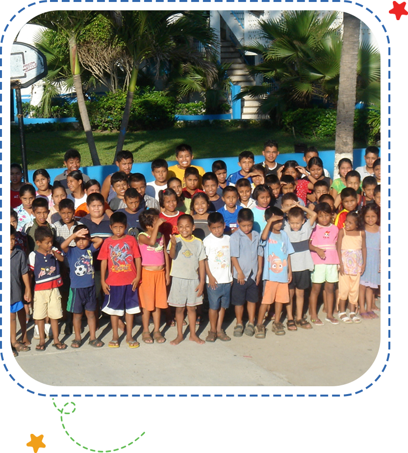 A group of children standing in front of a building.