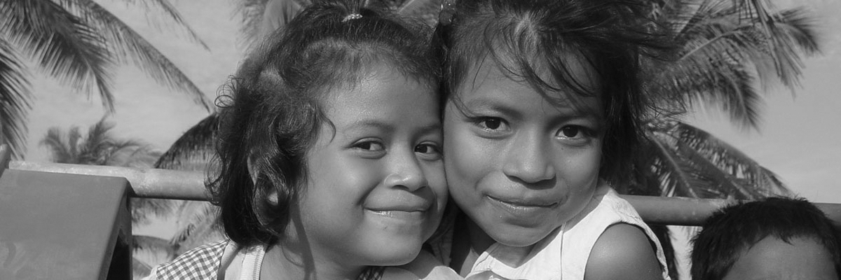 Two young girls smiling for a picture.