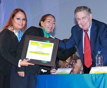 A woman holding a plaque with two men in front of her.