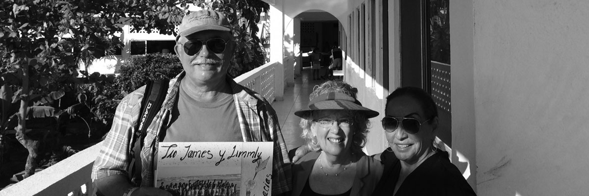 A black and white photo of three people holding signs.