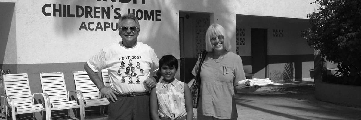 A family standing in front of a home.