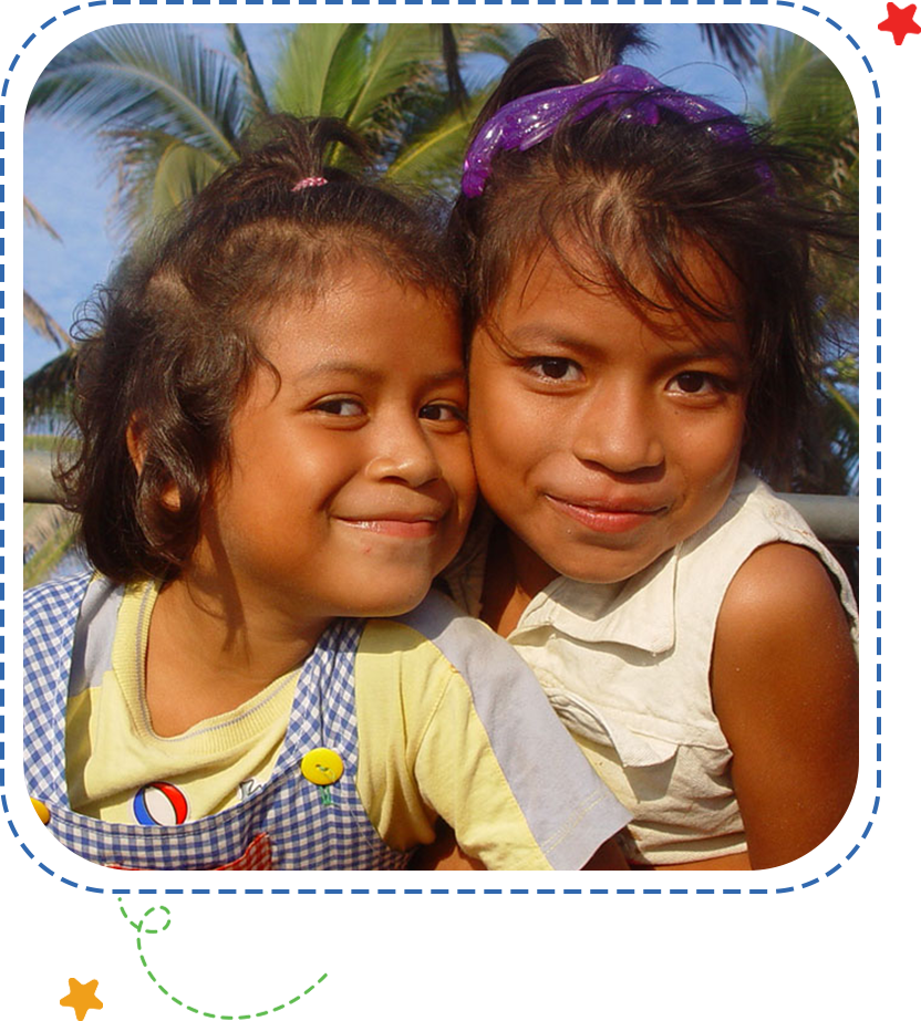 Two young girls posing for a picture.