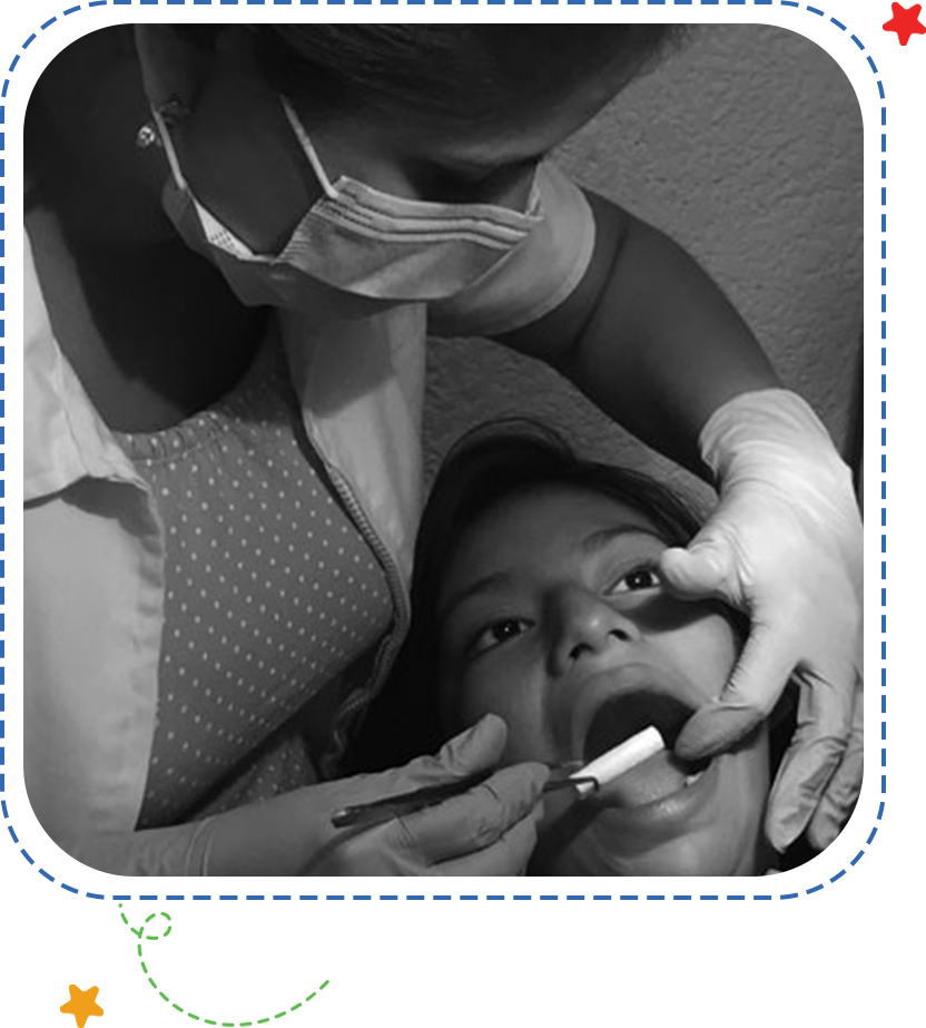 A woman is getting her teeth checked by an dentist.